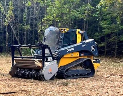 John Deere compact track loader with an FAE forestry mulcher on a freshly cleared lot